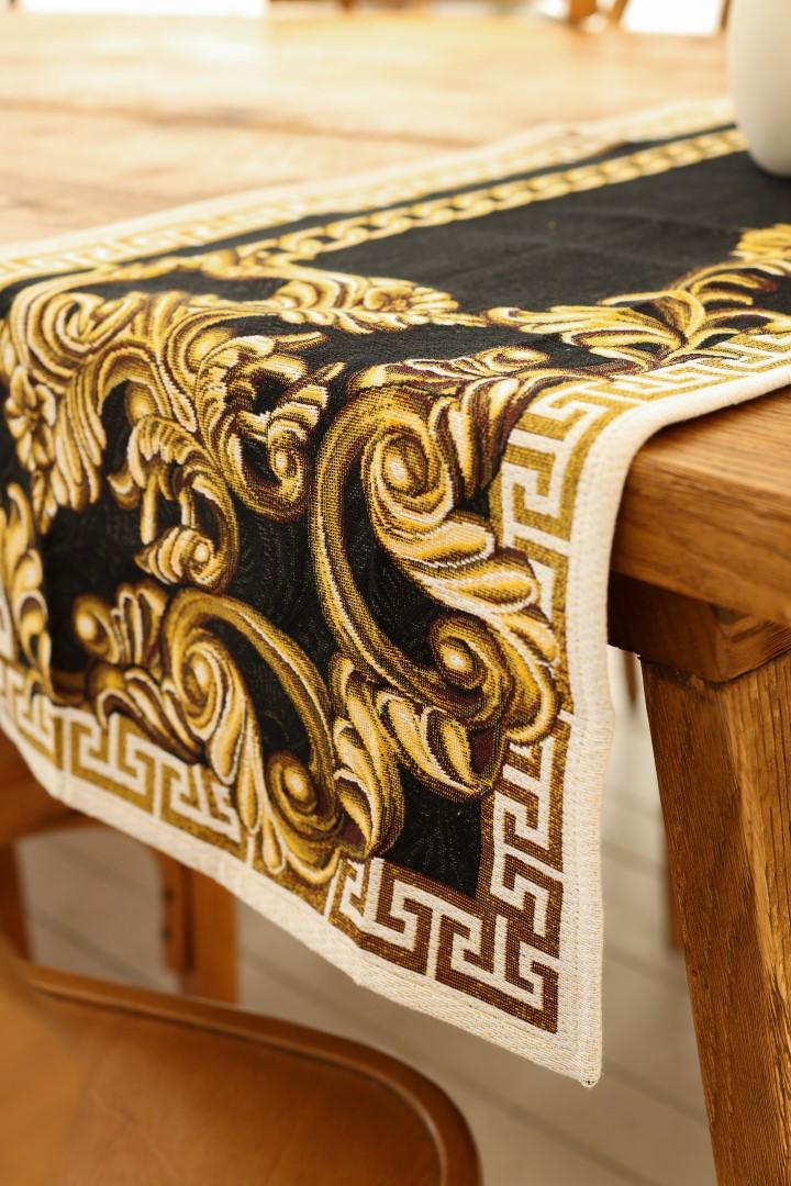 Close-up of a black and gold baroque table runner with ornate tapestry detailing
