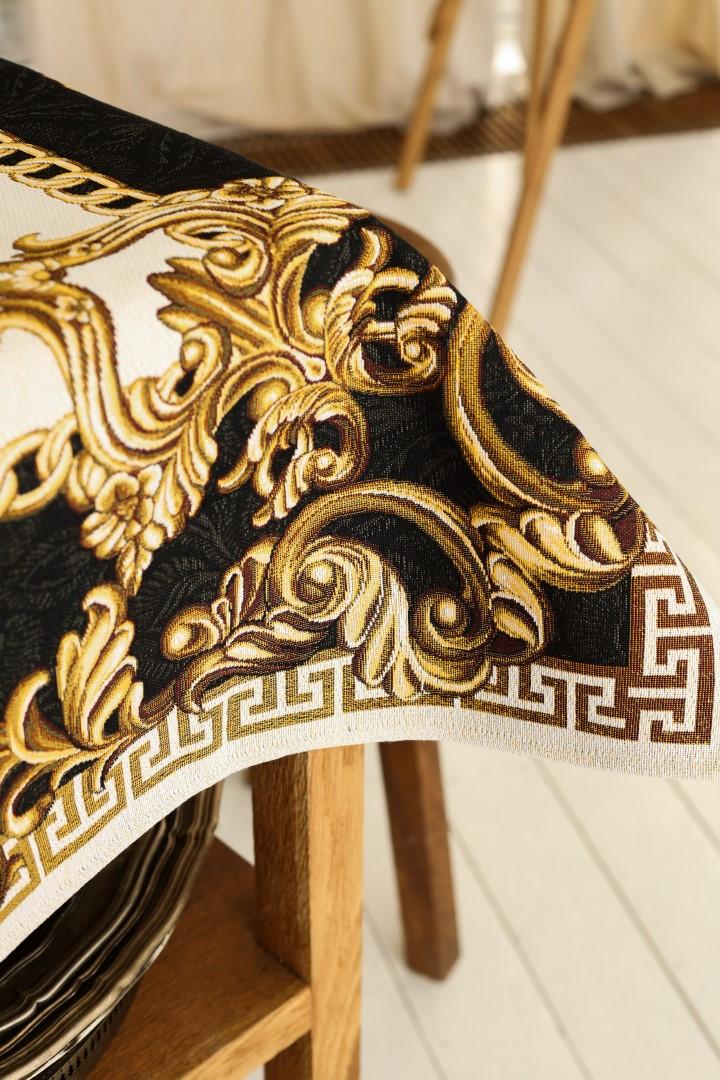 Close-up of gold and black baroque tablecloth with Medusa design