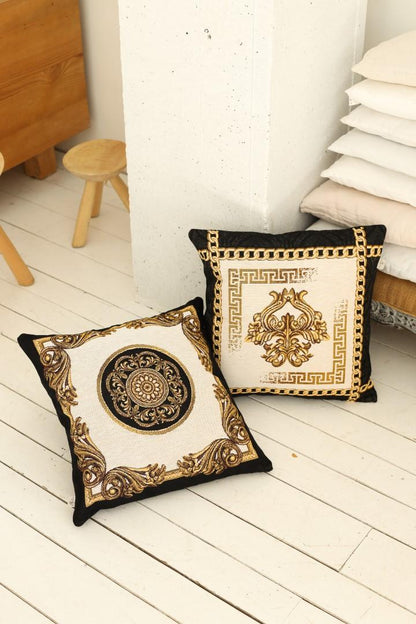 Baroque tapestry pillow set with gold ornamental designs displayed on a light wooden floor.