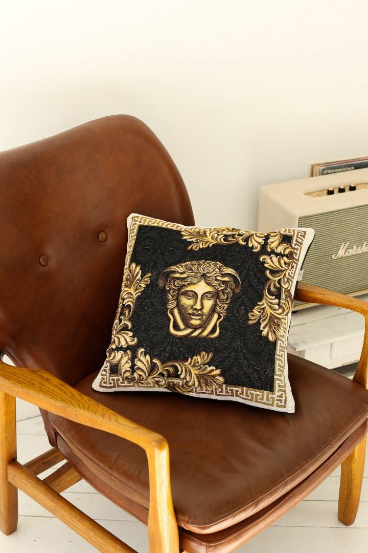 Black and gold Medusa tapestry pillowcase on leather armchair, luxury living room decor