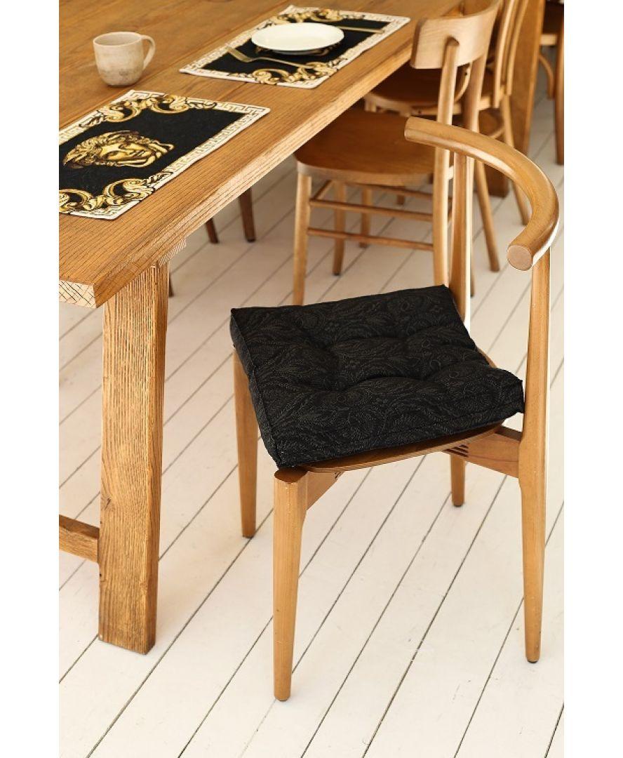 Black and gold Medusa tapestry placemats styled on wooden dining table