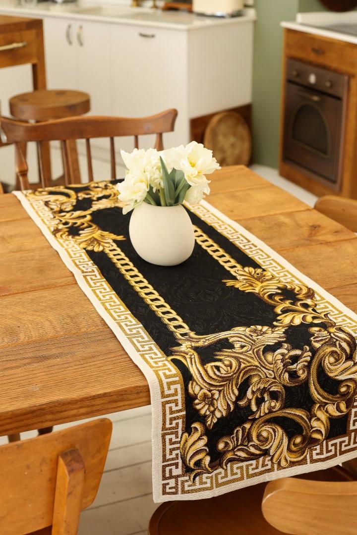 Black and gold baroque table runner on a wooden dining table with a white vase.