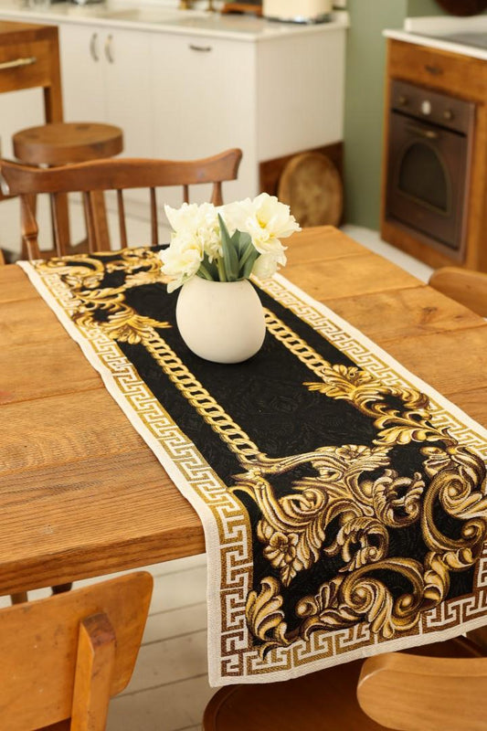 Black and gold baroque table runner on a wooden dining table with a white vase.