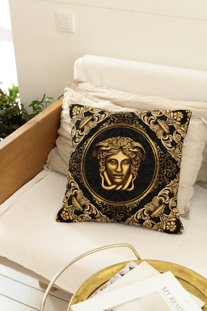 Black and gold baroque tapestry pillow on a white sofa