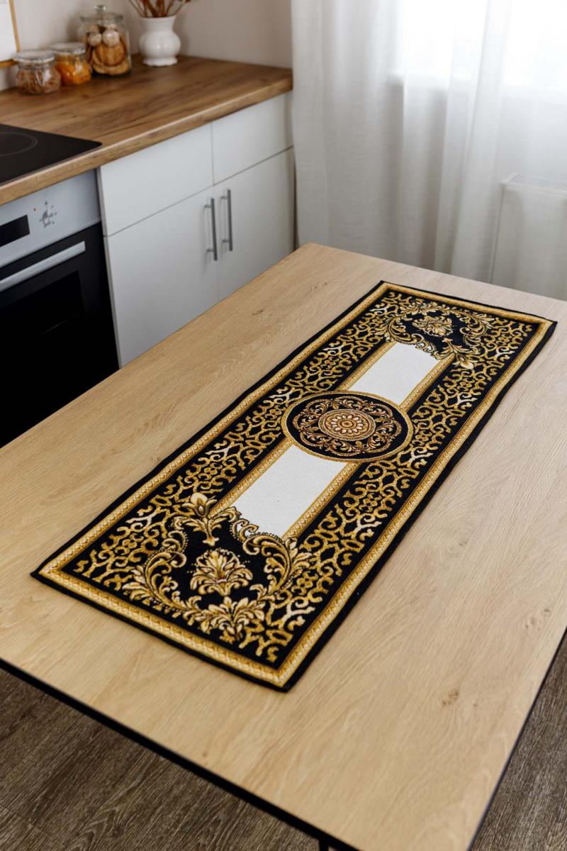 Black and gold baroque tapestry table runner displayed on a wooden kitchen table