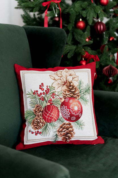 Christmas tapestry pillowcase with poinsettias, pinecones, and holiday ornaments — red festive cushion cover on a sofa