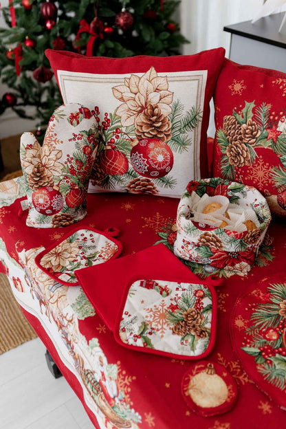 Christmas tapestry pillowcase with poinsettias, pinecones, and holiday ornaments — red festive cushion cover on a table