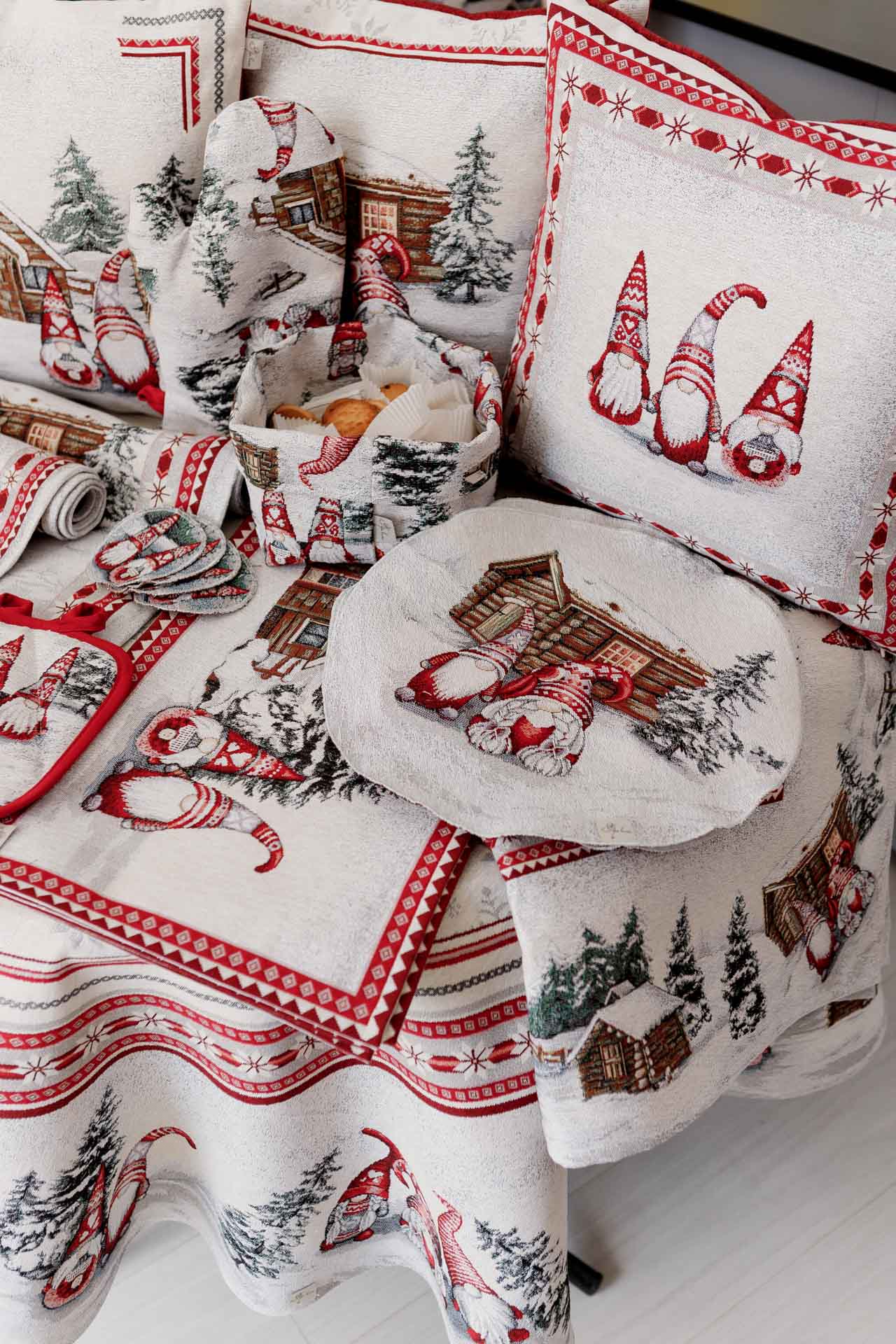 Christmas textile collection on table — tablecloth, oven mitt, pillow covers