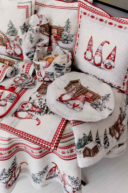 Christmas textile collection on table — tablecloth, oven mitt, pillow covers