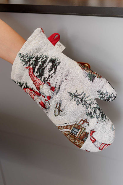 Close-up of Christmas gnome tapestry oven mitt with snowy cottage pattern