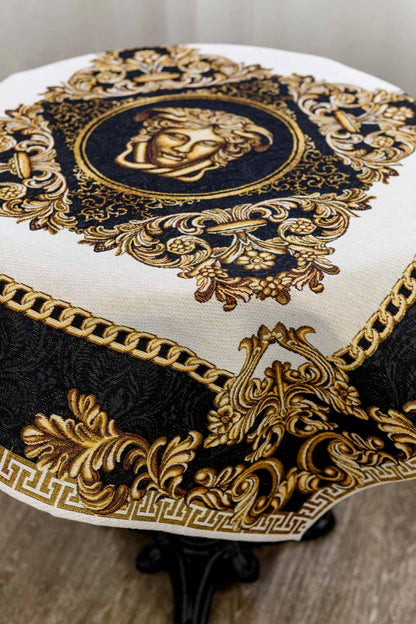 Close-up of baroque tablecloth with gold and black Medusa centerpiece