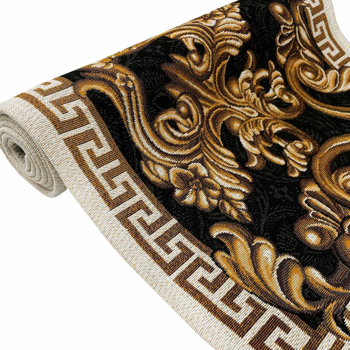 Close-up of black and gold baroque scrollwork on a tapestry table runner