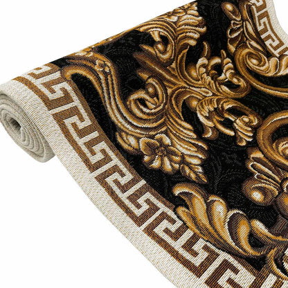 Close-up of black and gold baroque scrollwork on a tapestry table runner