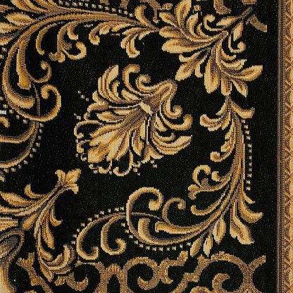 Close-up of black and gold baroque tapestry fabric showing woven floral ornament and decorative border