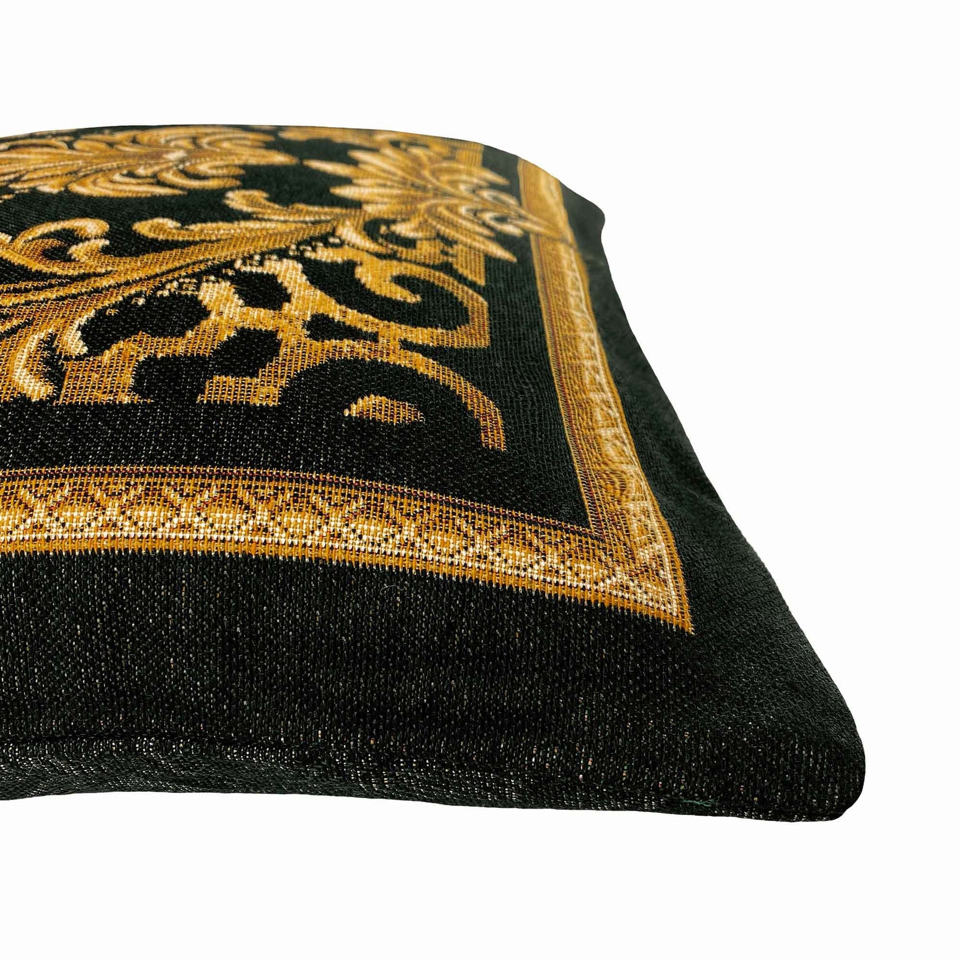 Close-up of black and gold baroque tapestry pillowcase showing detailed woven texture and gold scrollwork border