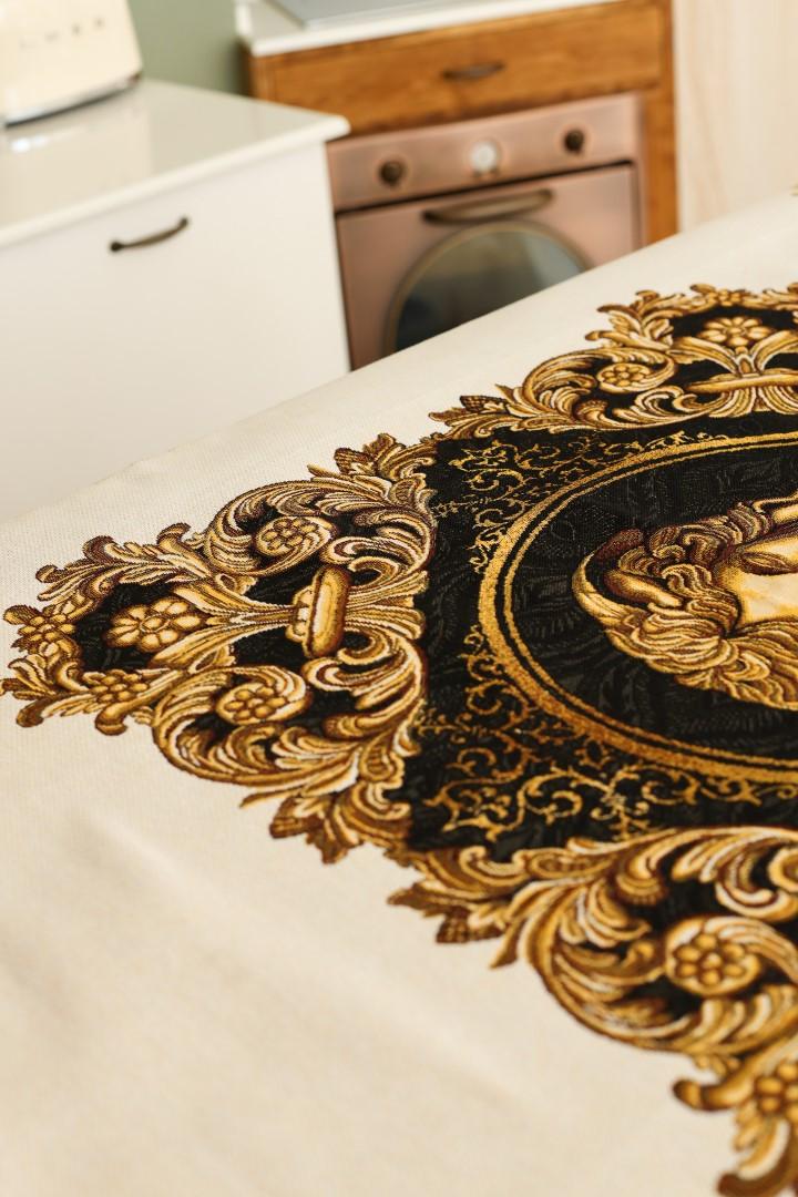 Close-up of gold and black baroque tablecloth with Medusa design