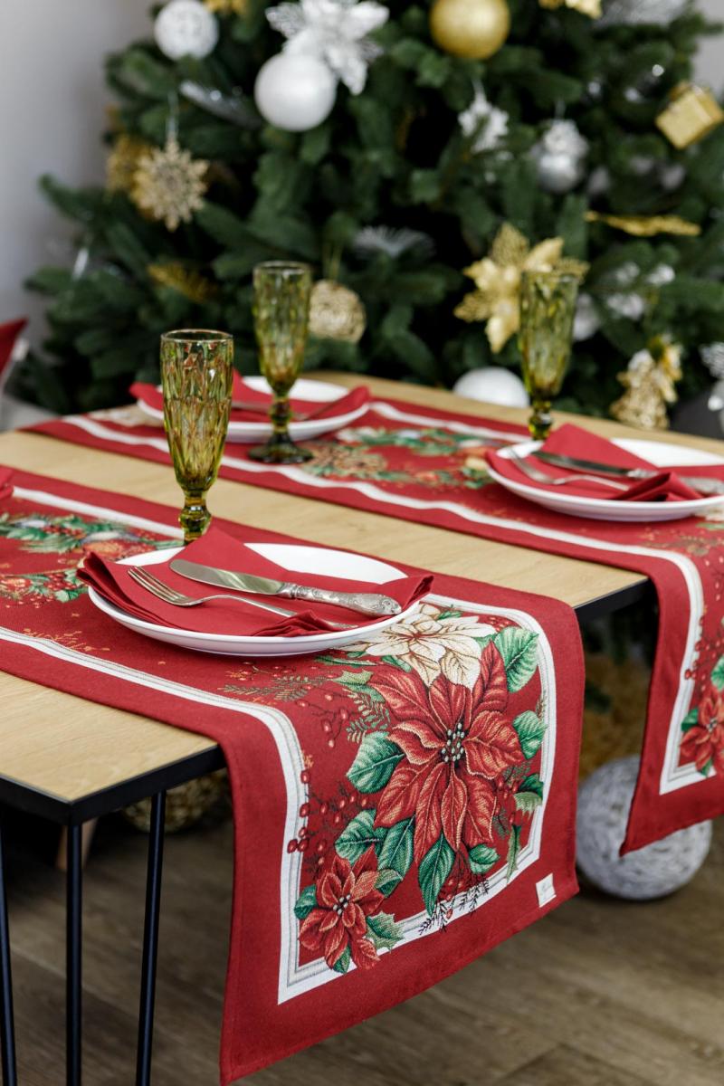 Close-up of red Christmas tapestry with poinsettia flowers and holiday wreath print