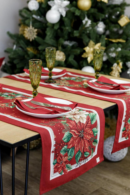 Close-up of red Christmas tapestry with poinsettia flowers and holiday wreath print
