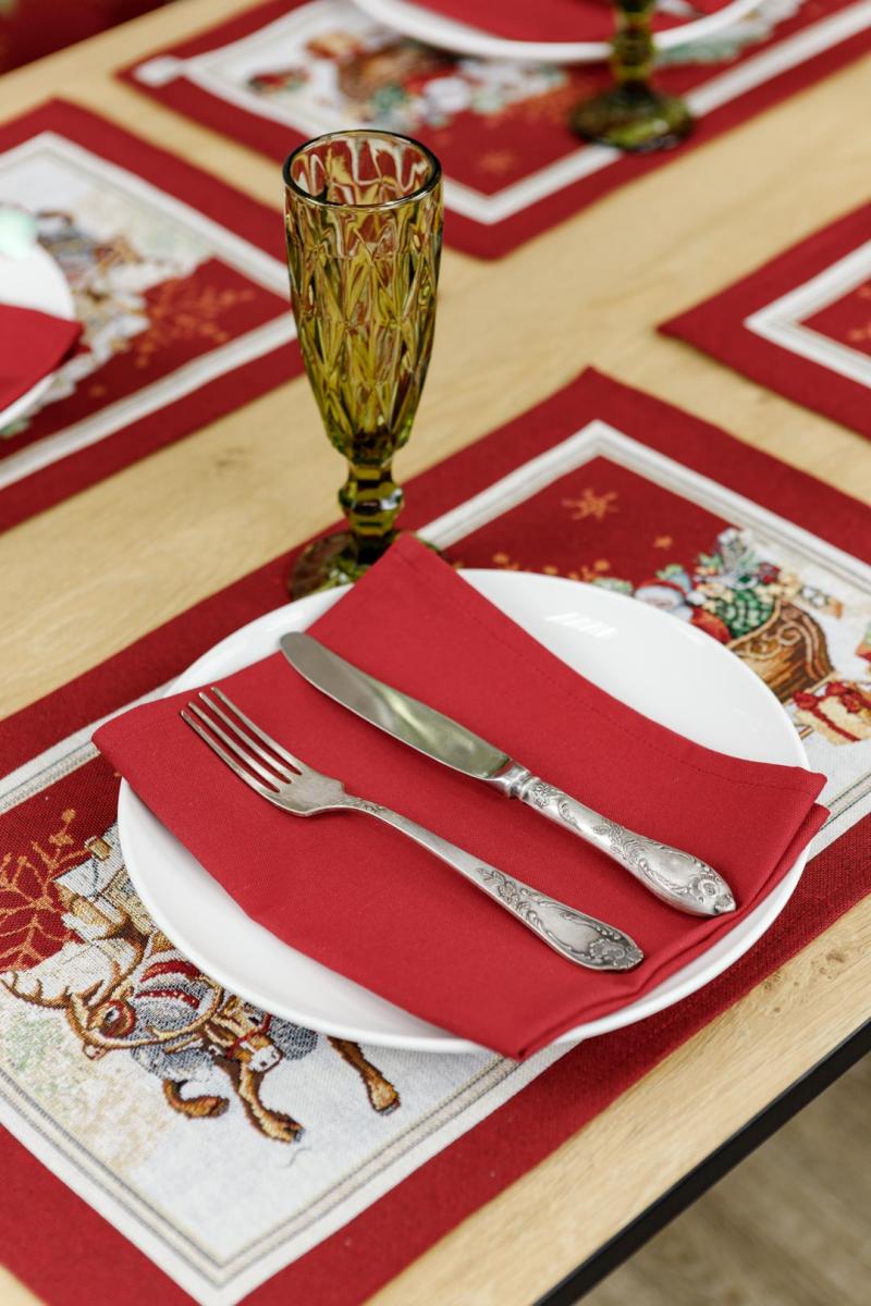Close-up of red woven tapestry placemat with Santa