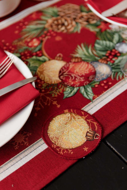 Close-up of woven tapestry fabric with poinsettia flowers, Christmas wreath, and gold ornaments.