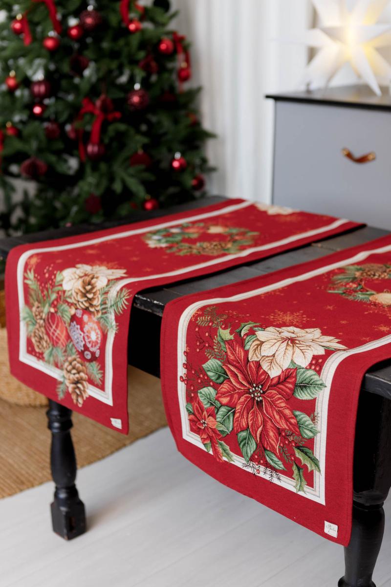 Close-up of woven tapestry fabric with poinsettia flowers, Christmas wreath, and gold ornaments