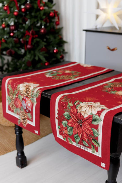 Close-up of woven tapestry fabric with poinsettia flowers, Christmas wreath, and gold ornaments