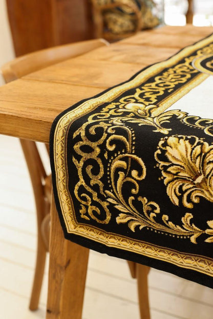 Detail of black and gold baroque table runner corner with ornate floral design on wooden table