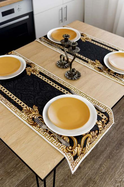 Dining table decorated with a black and gold baroque table runner and plates