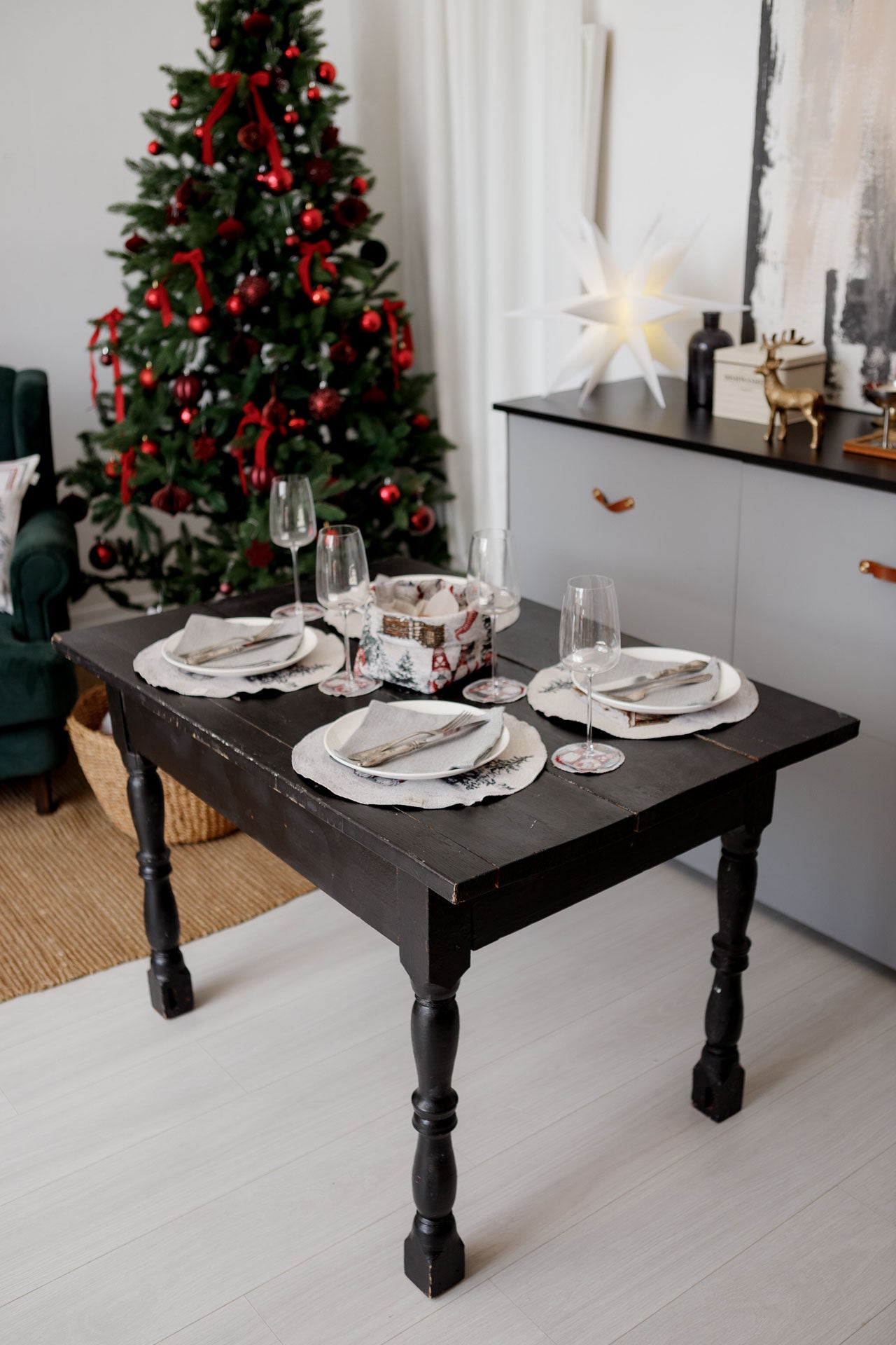 Festive dining table decorated with round gnome placemats, coasters, and Christmas basket