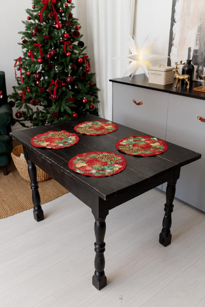 Festive round tapestry placemats with holiday ornament pattern on red fabric