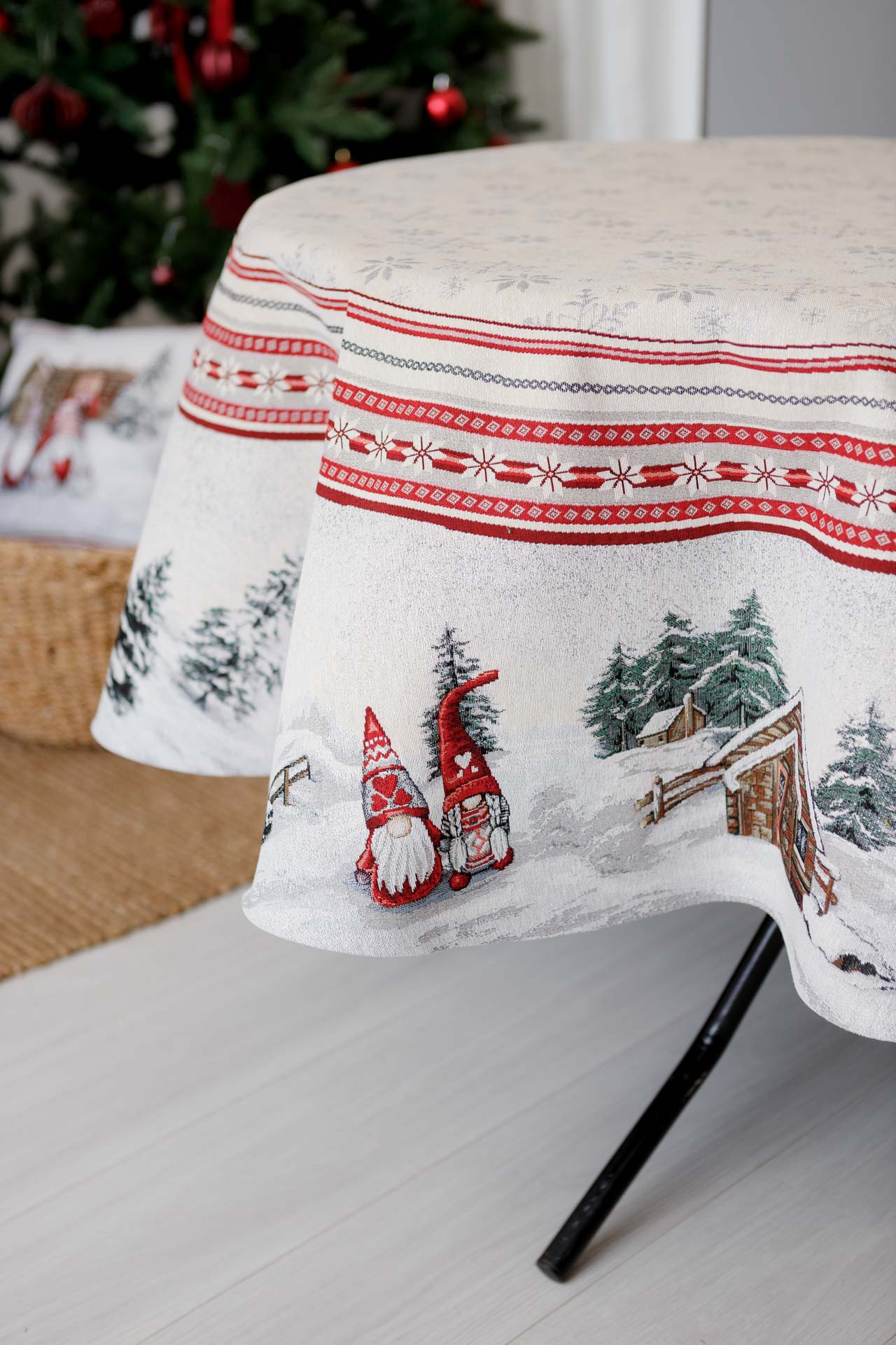 Gnome tapestry detail on round winter tablecloth fabric