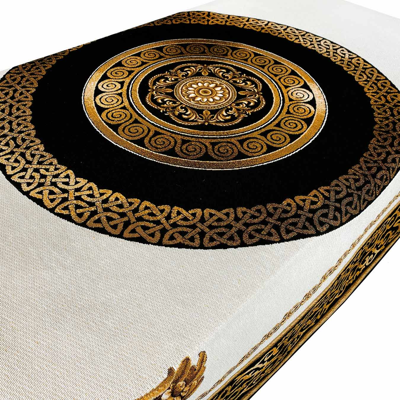 Gold and black medallion pattern on baroque tapestry tablecloth, detailed close-up.