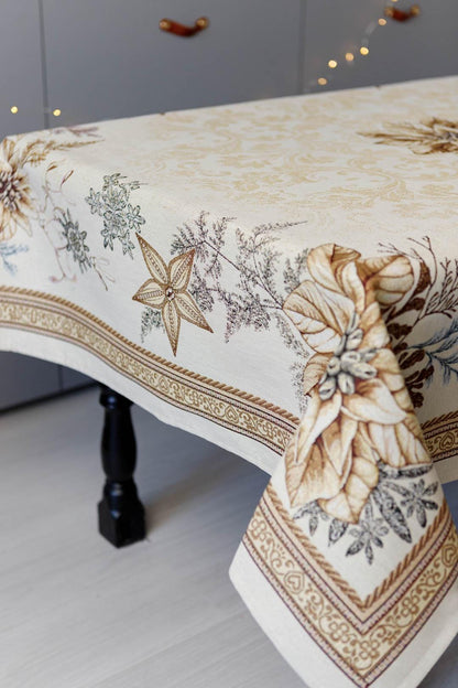 Woven tapestry tablecloth with Christmas poinsettia flower design. Beige and gold. Made in Ukraine.