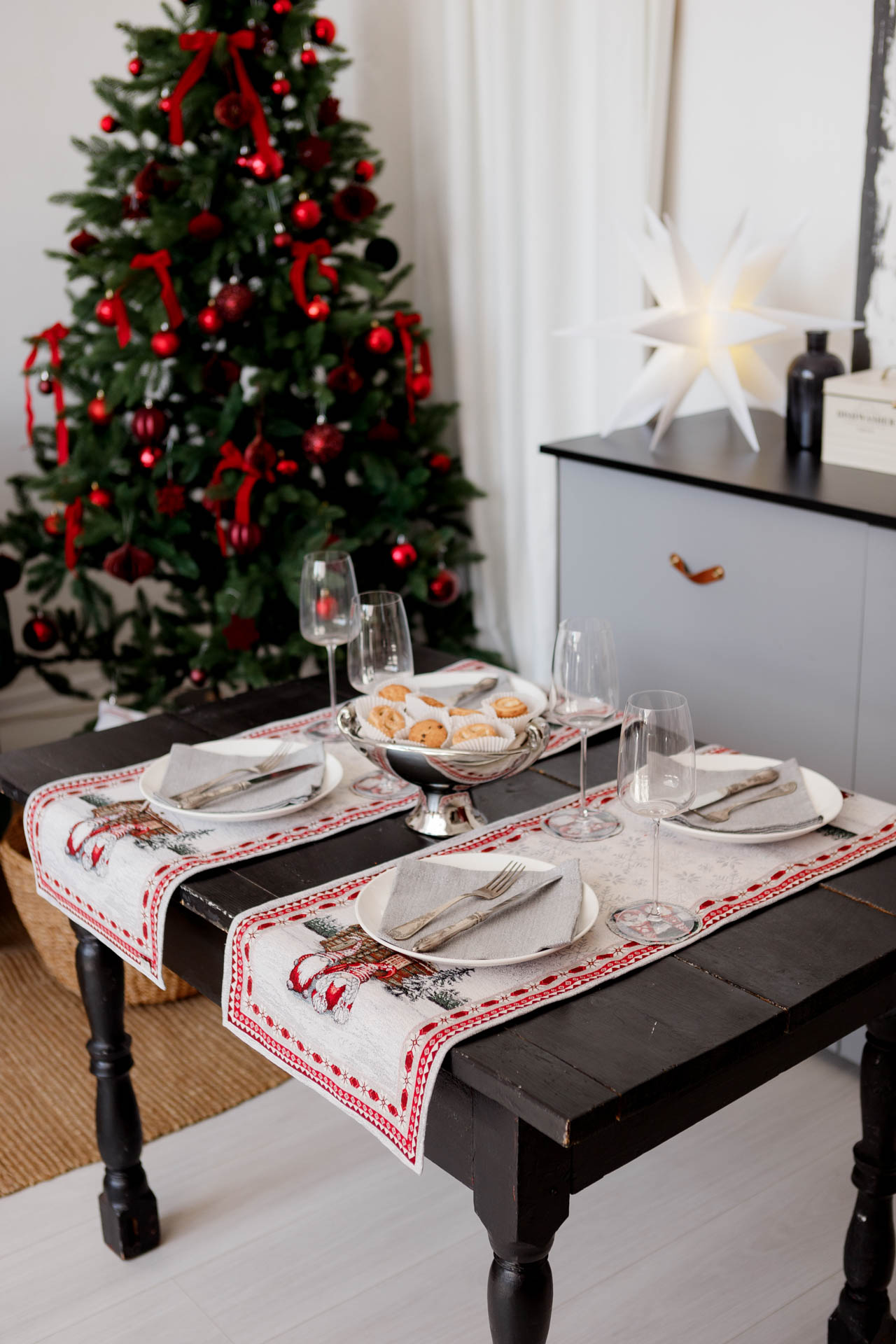 Holiday dining table decorated with Christmas gnome table runners and festive place settings.