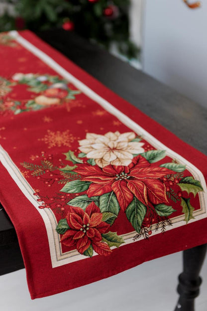 Holiday gift presentation of red poinsettia tapestry table runner