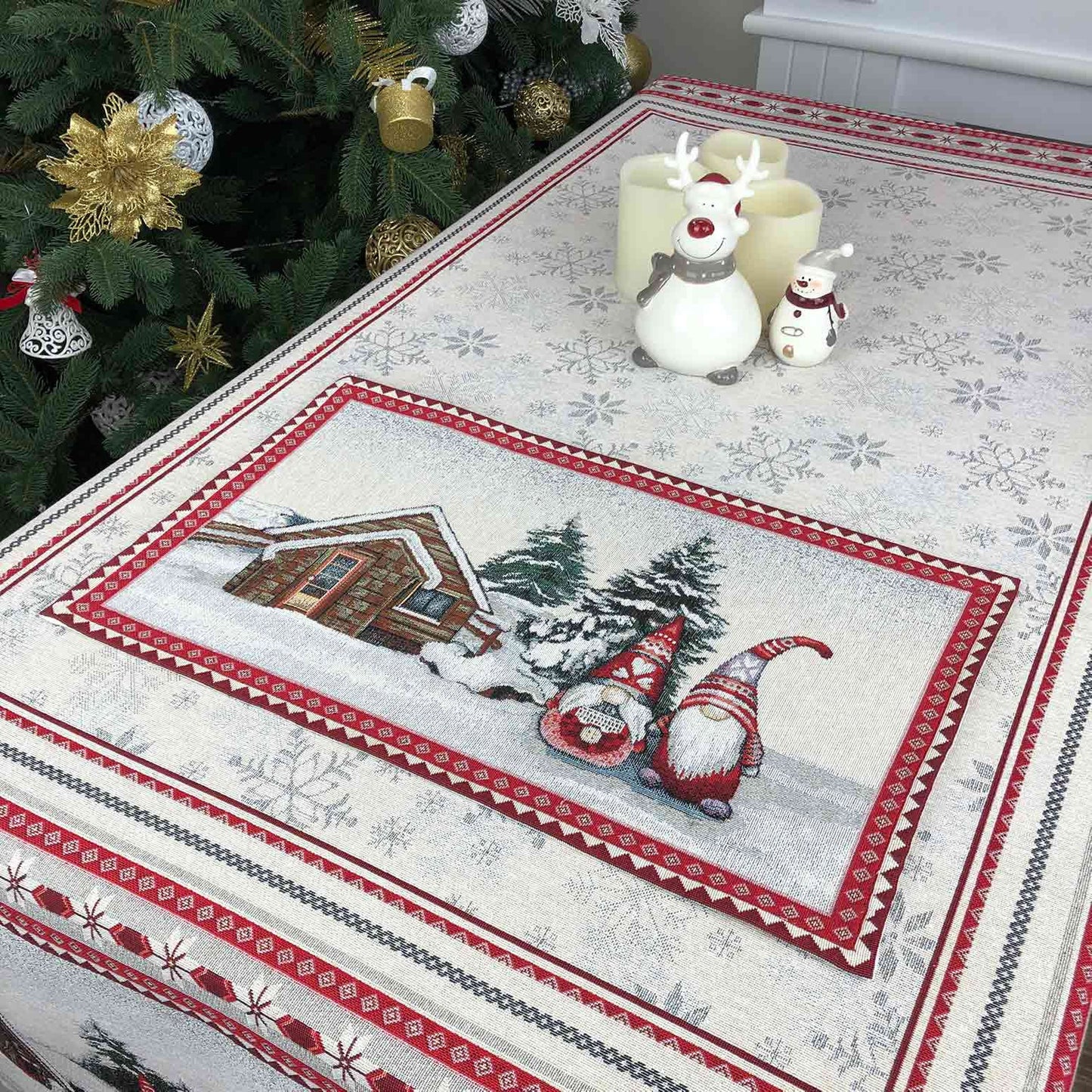 Holiday tapestry placemat with gnomes and snowy cottage arranged on a table, festive home setting