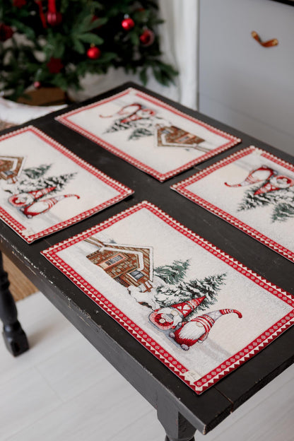 Holiday tapestry placemats with gnomes and snowy cottage arranged on a table, festive home setting