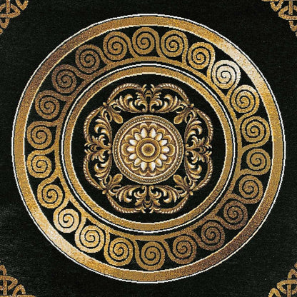 Intricate gold circular emblem on black tapestry fabric, baroque tablecloth design.