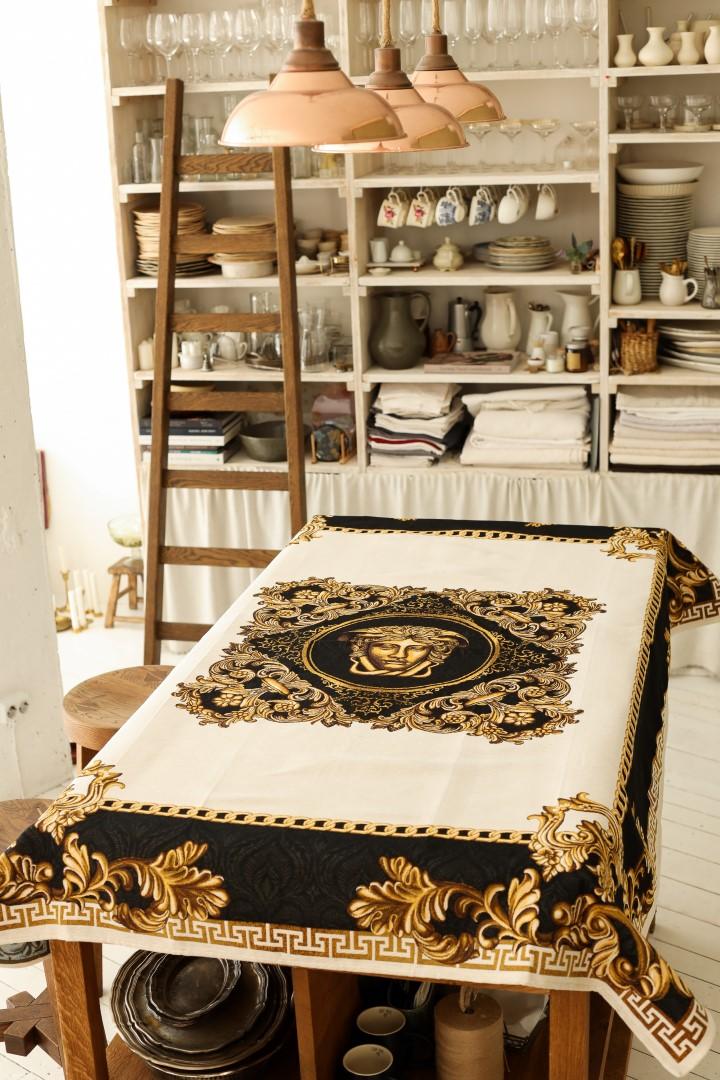 Large baroque tablecloth with Medusa motif displayed in a kitchen interior