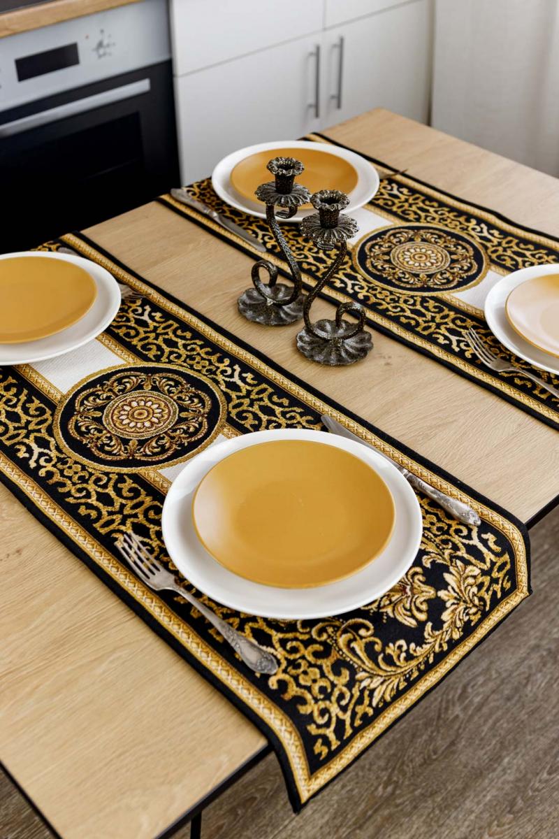 Luxury black and gold baroque tapestry table runners styled on a wooden dining table