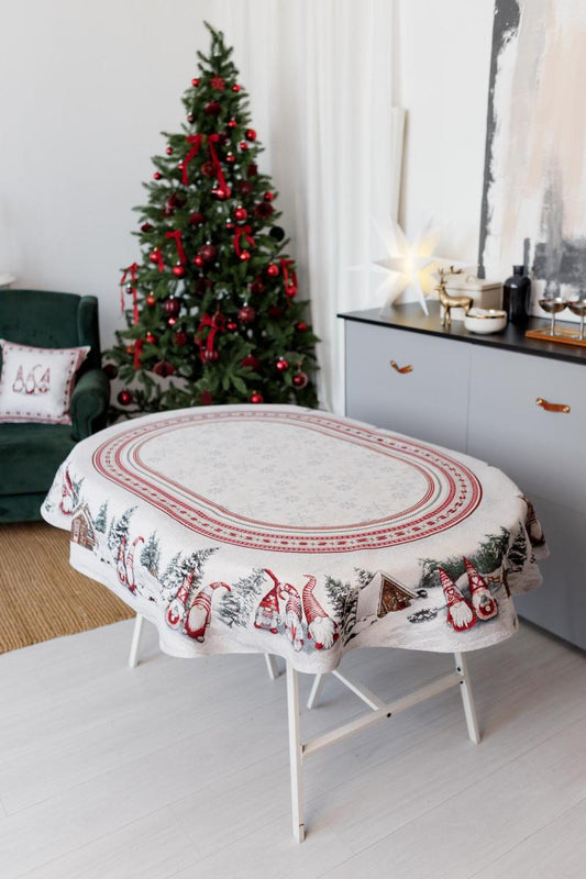 Oval Christmas tapestry tablecloth with gnomes and snowy cottage design, festive holiday dining decor