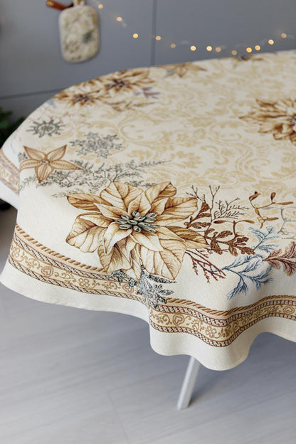 Oval woven tapestry tablecloth with Christmas poinsettia flower design. Beige and gold. Made in Ukraine.