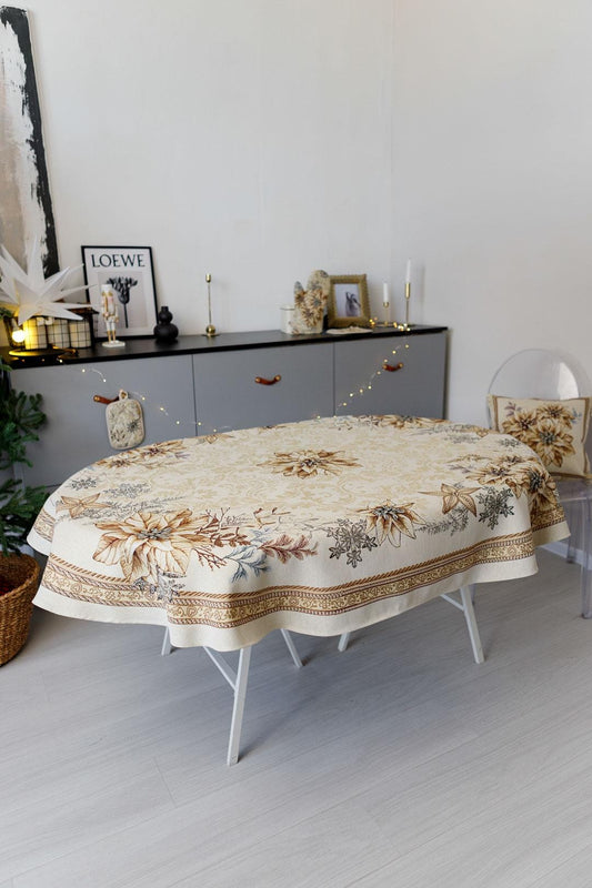 Oval woven tapestry tablecloth with Christmas poinsettia flower design. Beige and gold. Made in Ukraine.