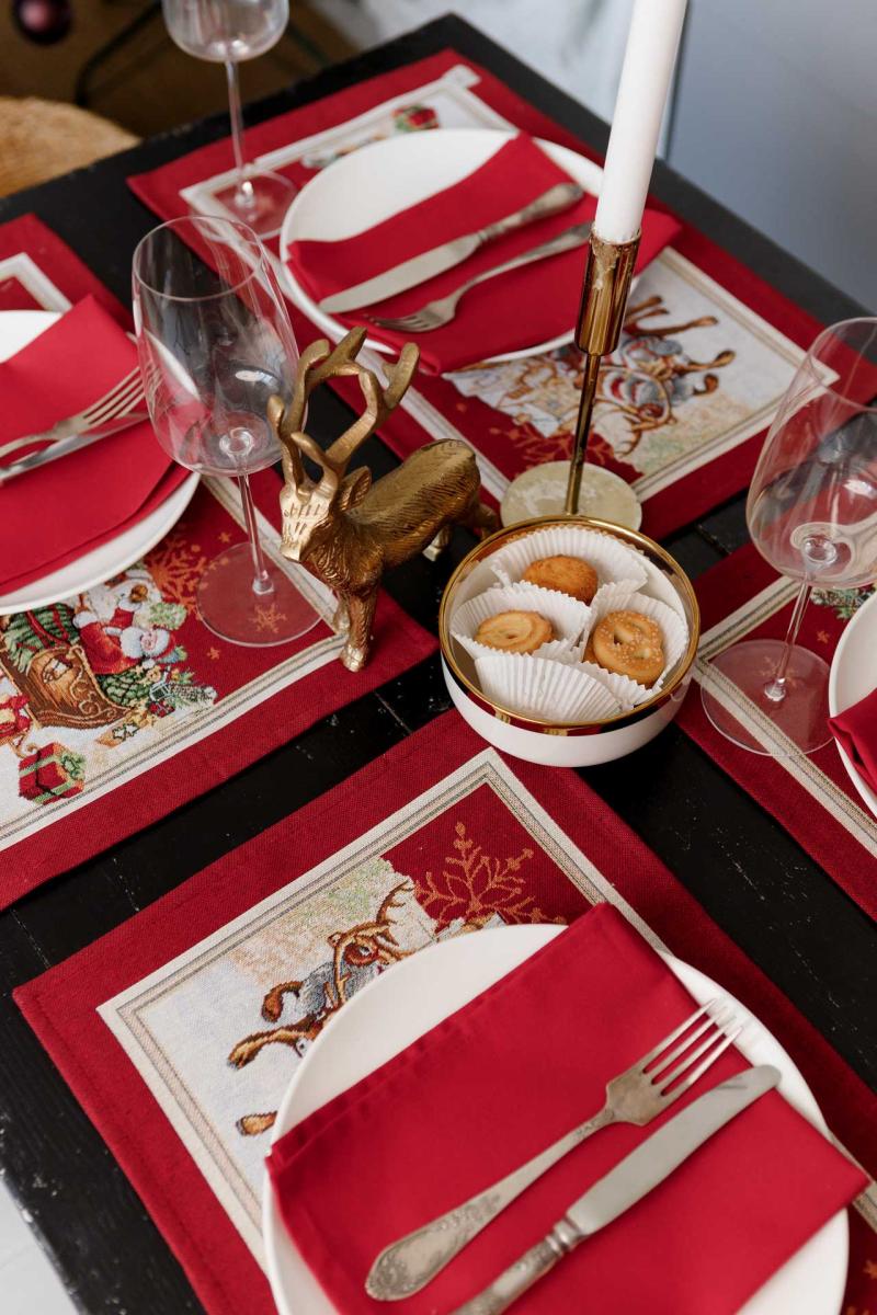 Red Christmas placemat on wooden dining table
