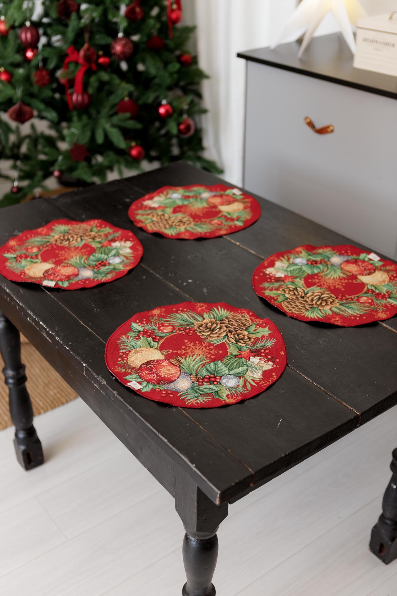 Red Christmas table decor placemat with pine branches and gold ornaments
