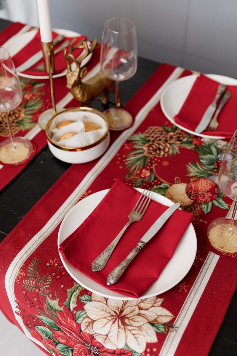 Red festive table runner placed on a holiday table
