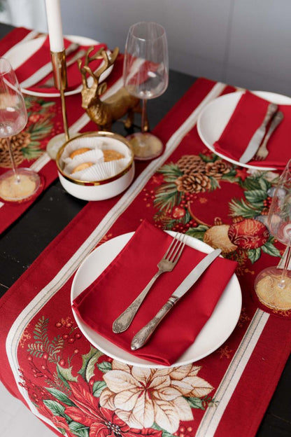 Red festive table runner placed on a holiday table
