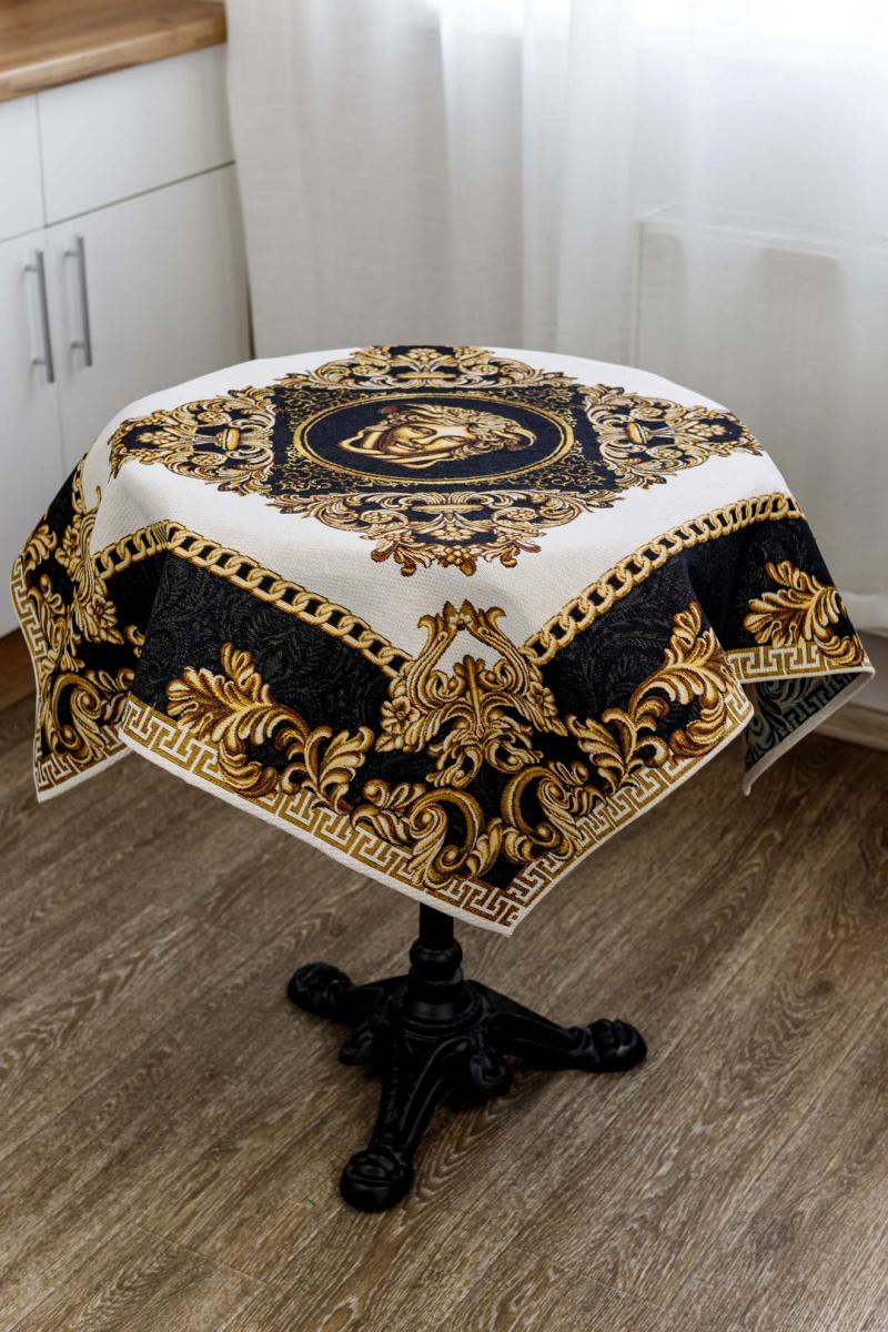 Round baroque tablecloth with gold and black Medusa design on a small table