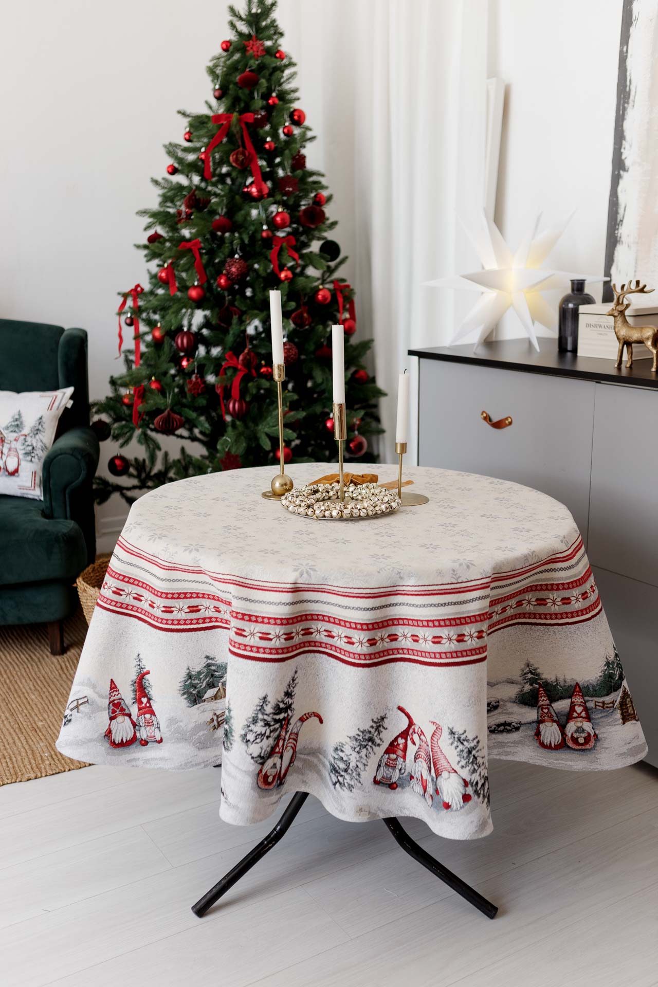 Round festive tablecloth styled with candles and gold decor
