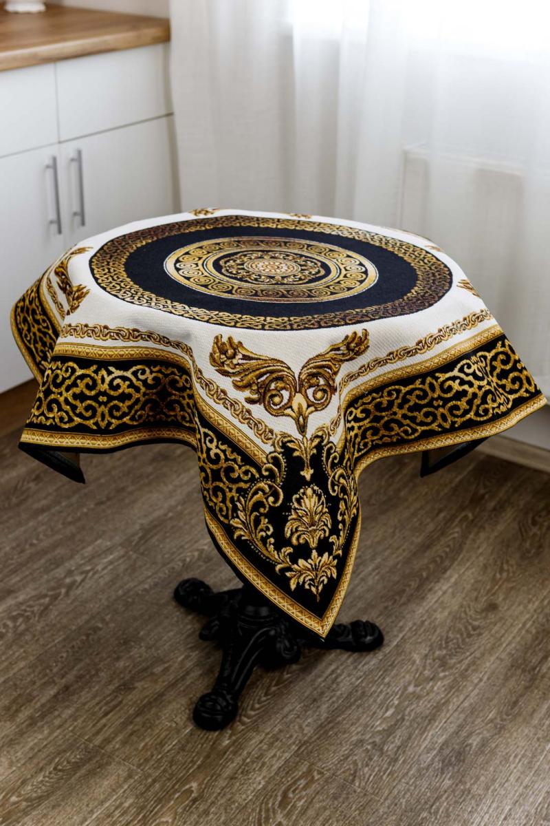 Square baroque tapestry tablecloth with gold medallion displayed on round table.